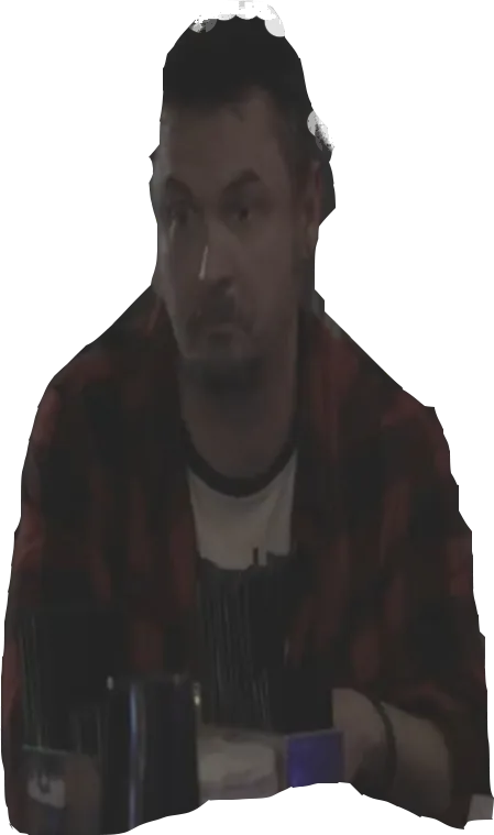 Chet in a flannel shirt, arms folded at the bar