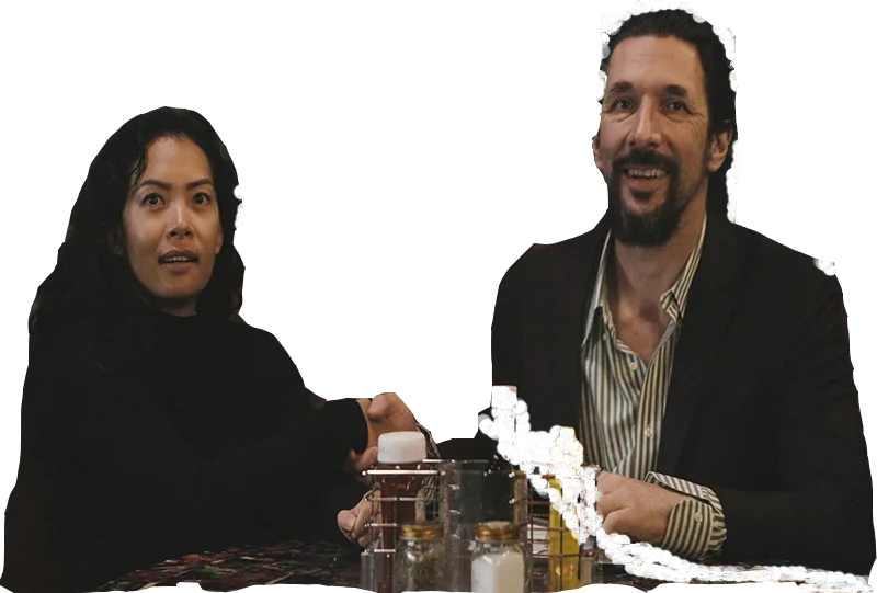 Emily across the table from Brady during her job interview