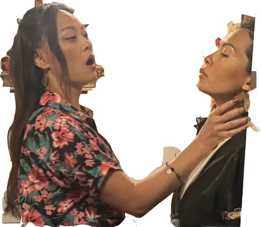 Gigi, in a floral shirt, pinning Emily against the wall by the throat